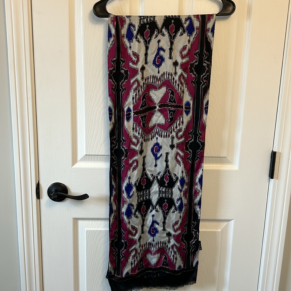 Gucci 100% silk scarf. Black with magenta and blue design. 12x70 inches.